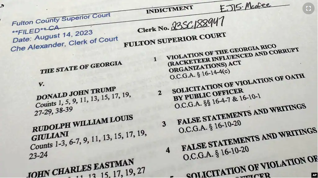 The indictment in Georgia against former President Donald Trump is photographed Monday, Aug. 14, 2023. (AP Photo/Jon Elswick)