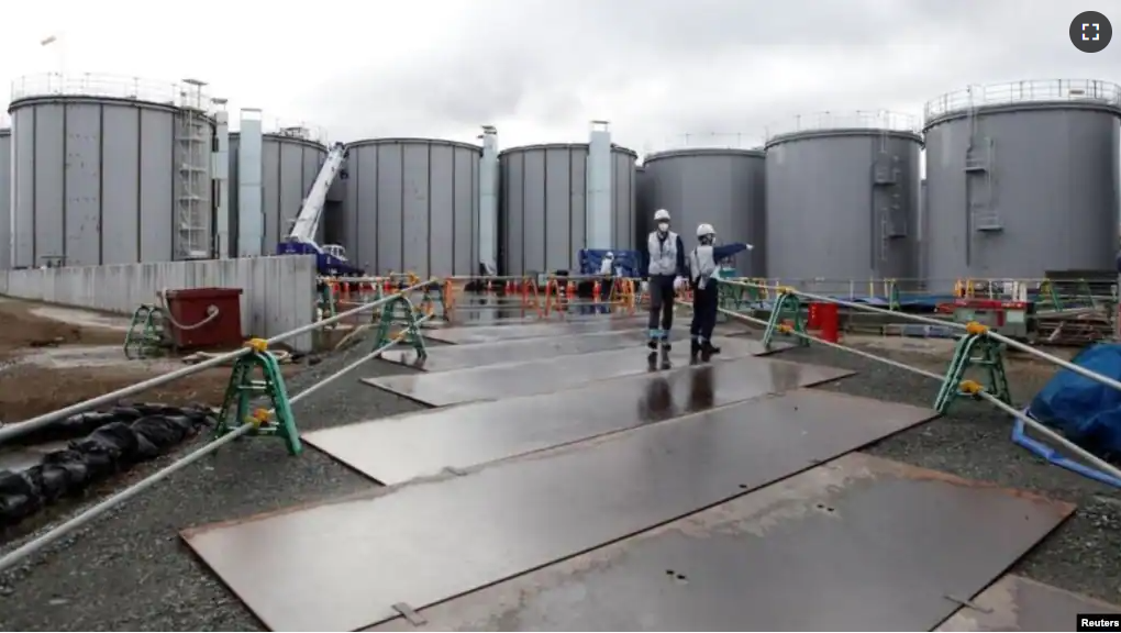 FILE - Workers are seen near storage tanks for radioactive water at Tokyo Electric Power Co's (TEPCO) tsunami-crippled Fukushima Daiichi nuclear power plant in Okuma town, Fukushima prefecture, Japan. January 15, 2020. (REUTERS/Aaron Sheldrick)