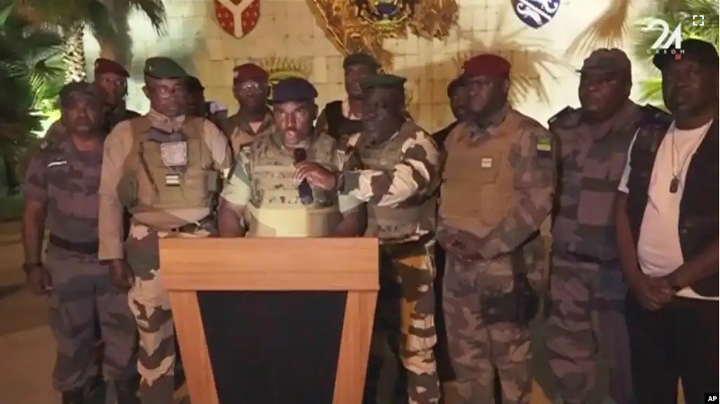 This video grab shows soldiers speaking on state television as they announce that they had seized power in Libreville, Wednesday Aug. 30, 2023. (GABON 24 via AP)