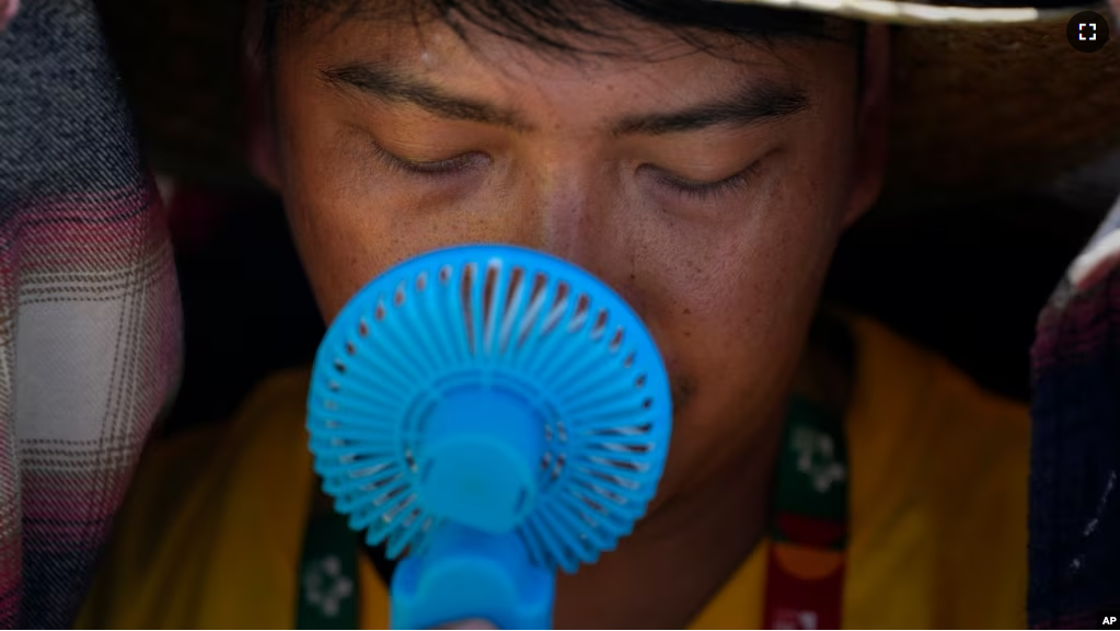 FILE - A man cools off from the intense heat in Lisbon, Portugal on Aug. 6, 2023. UN weather agency says Earth had the hottest summer ever in the northern hemisphere. (AP Photo/Armando Franca, File)