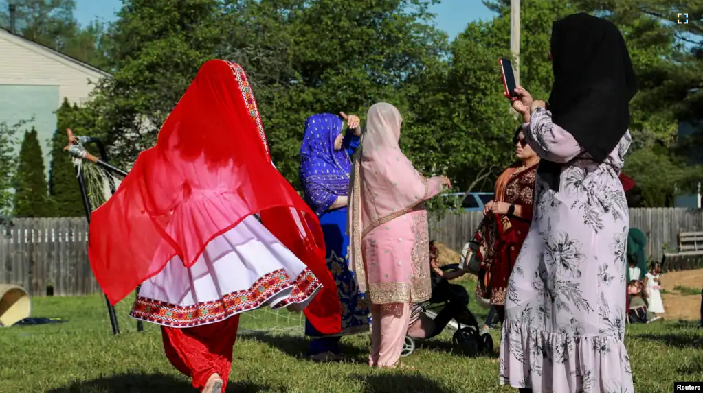 FILE - Afghan refugees dress in traditional clothes while celebrating the Muslim festival in Louisville, Kentucky, U.S., May 2, 2022. (REUTERS/Amira Karaoud/File Photo)