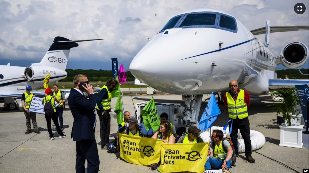 FILE - Environmental activists chained themselves to a plane at the Geneve Aeroport in Geneva, Switzerland, May 23, 2023. (Laurent Gillieron/Keystone via AP, File)