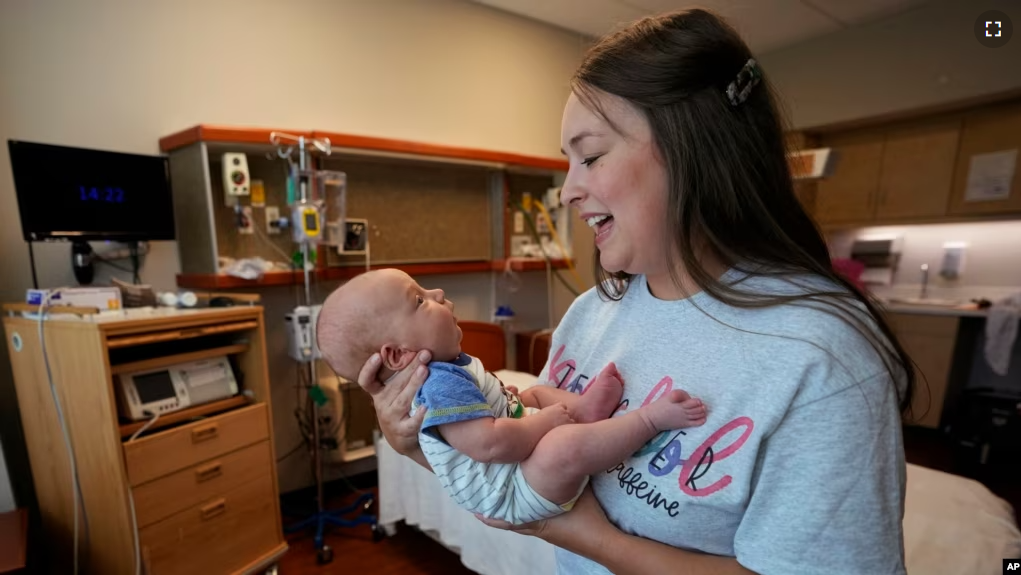 Katie O'Brien holds her son, Bennett, on Tuesday, Aug. 29, 2023, in the birthing room where she delivered him in July at the Henry County Medical Center in Paris, Tenn. (AP Photo/Mark Humphrey)