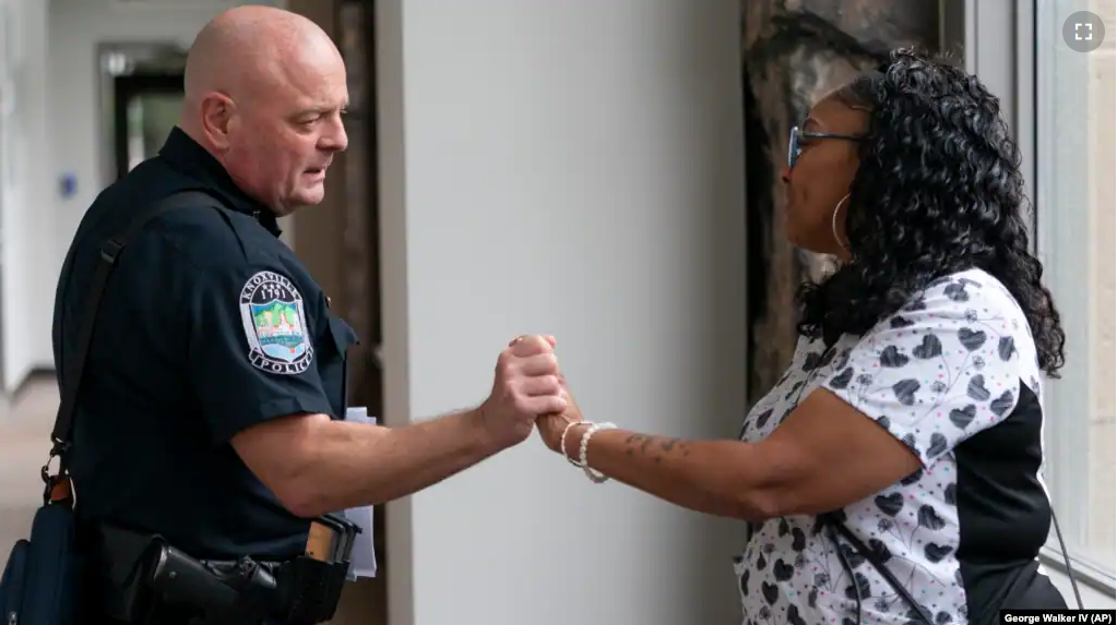 Knoxville Deputy Police Chief Tony Willis talks with Terry Walker-Smith after a meeting of the Violence Reduction Leadership Committee on Thursday, Aug. 3, 2023, in Knoxville, Tenn. (AP Photo/George Walker IV)