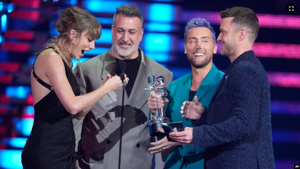 Joey Fatone, from center, Lance Bass, and Justin Timberlake of NSYNC present the award for best pop to Taylor Swift, far left, for "Anti-Hero" during the MTV Video Music Awards on September 12, 2023, at the Prudential Center in Newark, N.J. (Photo by Charles Sykes/Invision/AP)