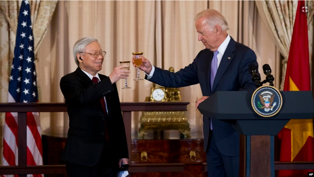 FILE - Then-Vice President Joe Biden, right, toasts with General Secretary of the Communist Party of Vietnam Nguyen Phu Trong, during a luncheon gathering in honor of Nguyen at the Department of State in Washington, July 7, 2015. (AP Photo/Manuel Balce Ceneta)