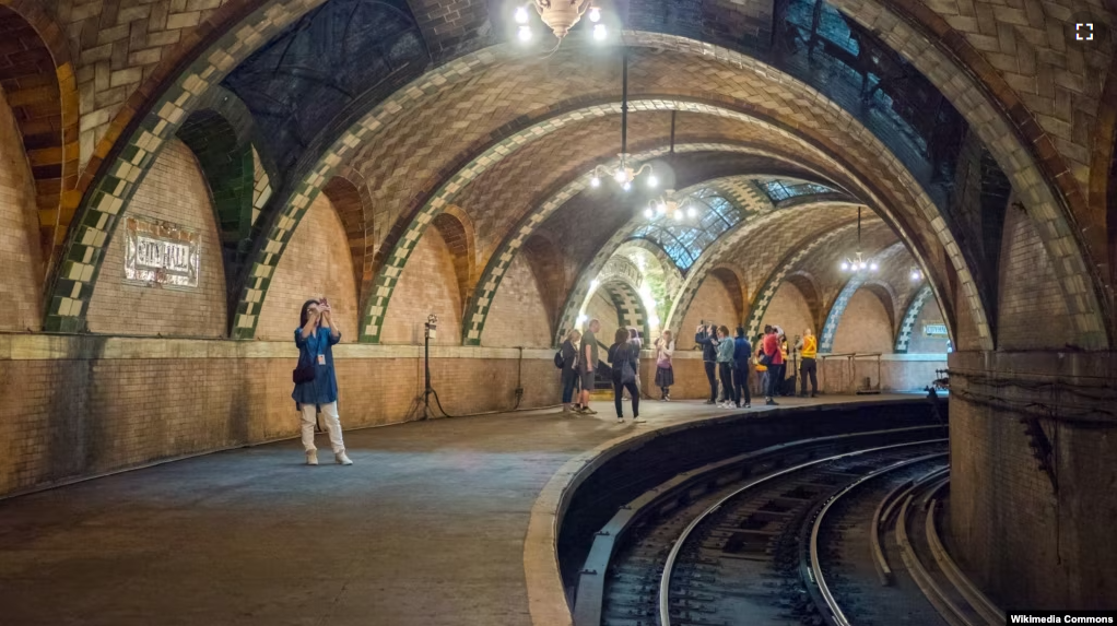 FILE - Visitors take pictures during a tour of the City Hall Station, New York City, June 3, 2018.