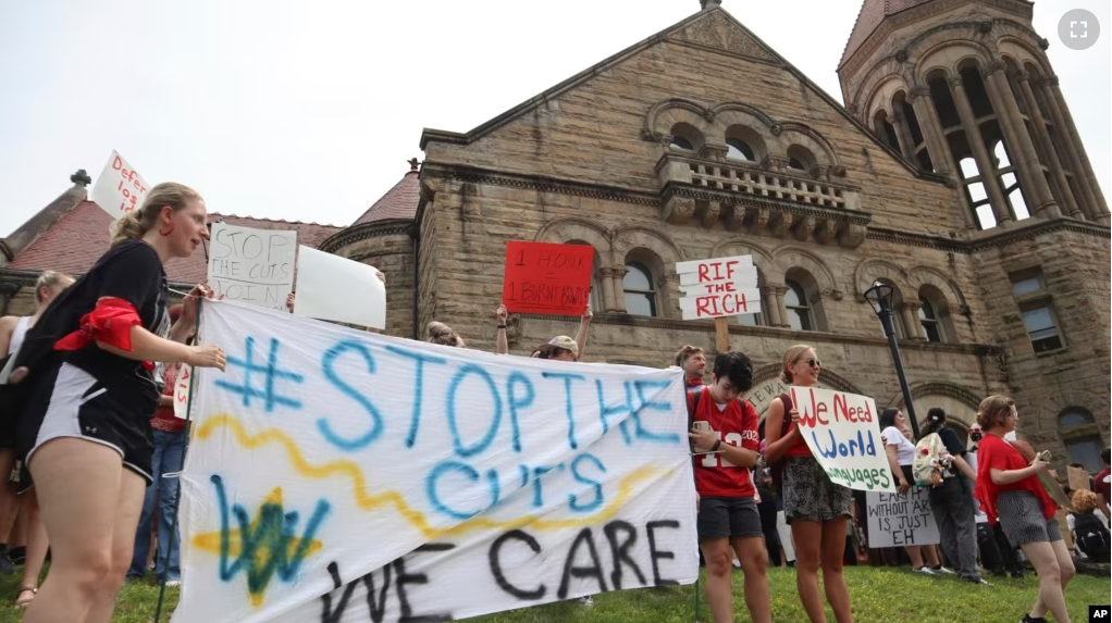 West Virginia University students lead a protest against cuts to programs in world languages, creative writing and more amid a $45 million budget deficit outside Stewart Hall in Morgantown, W.Va., on Monday, Aug. 21, 2023. (AP Photo/Leah Willingham)