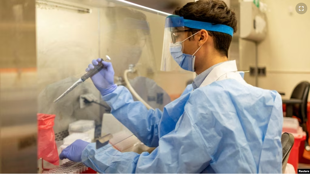 In this file photo, a student at the University of Pennsylvania’s Perelman School of Medicine in Philadelphia, Pennsylvania demonstrates a viral RNA extraction on December 16, 2021. (REUTERS/Hannah Beier)