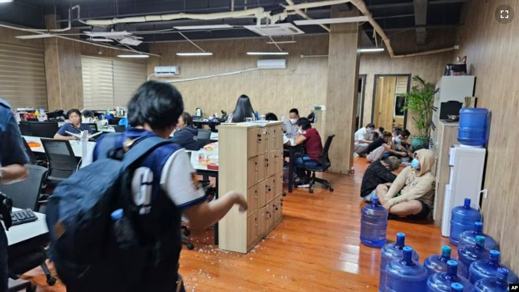 FILE - In this photo provided by the Philippine National Police Anti-Cybercrime Group, police walks inside one of the offices they raided in Las Pinas, Philippines, on June 27, 2023. (Philippine National Police Anti-Cybercrime Group via AP, File)