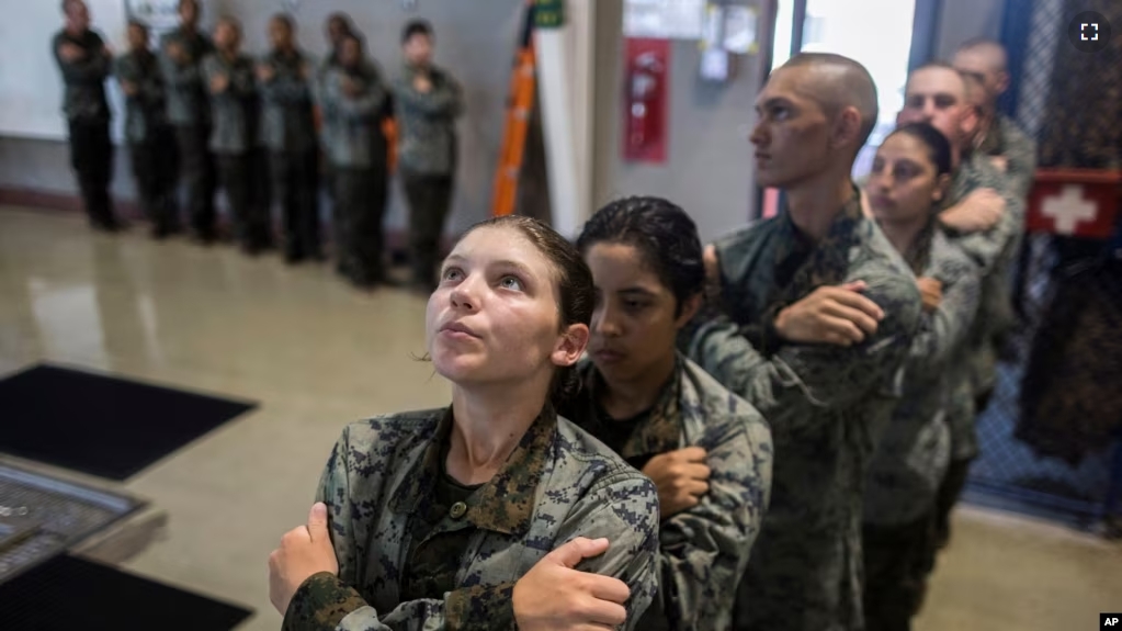 A group of U.S. Marine Corps recruits wait inline before swim training at the Marine Corps Recruit Depot pool, Wednesday, June 28, 2023, in Parris Island, S.C. (AP Photo/Stephen B. Morton)