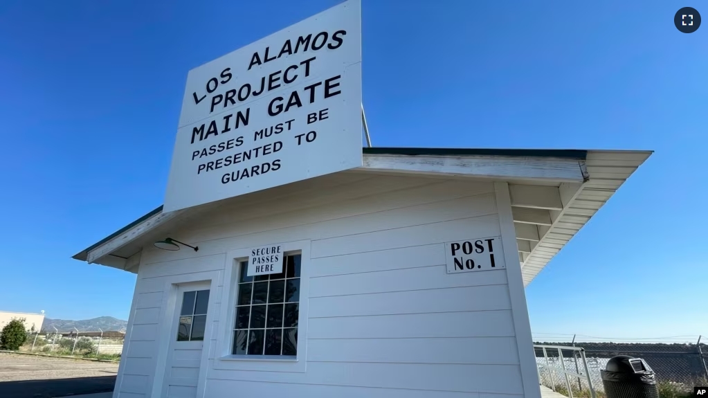 A sign marks a roadside rest stop that has been made to look like the historic security gate that all Manhattan Project workers passed through in Los Alamos, N.M., on June 26, 2023. (AP Photo/Susan Montoya Bryan)