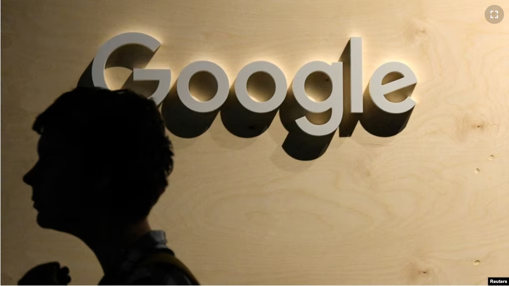 FILE - A woman passes the logo from the web search engine provider Google during the digital society festival 're:publica', at the Arena Berlin in Berlin, Germany June 9, 2022. (REUTERS/Annegret Hilse)