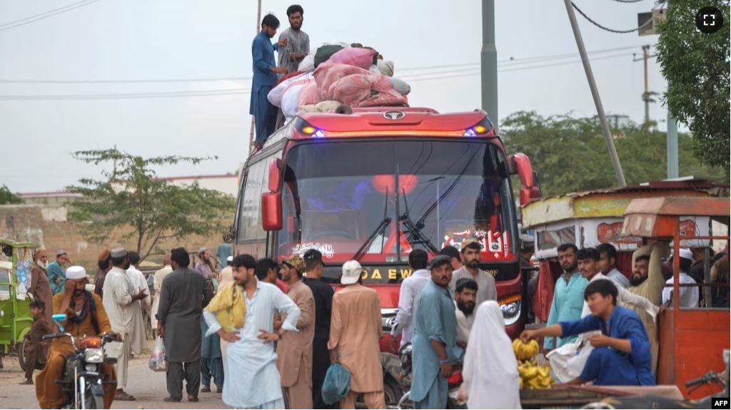 FILE - Afghan refugees board a bus from Karachi, Pakistan, to Afghanistan on Sept. 21, 2023. Pakistan, on Oct. 3, 2023, ordered undocumented immigrants to leave the country by Nov. 1. (Photo by Rizwan TABASSUM / AFP)