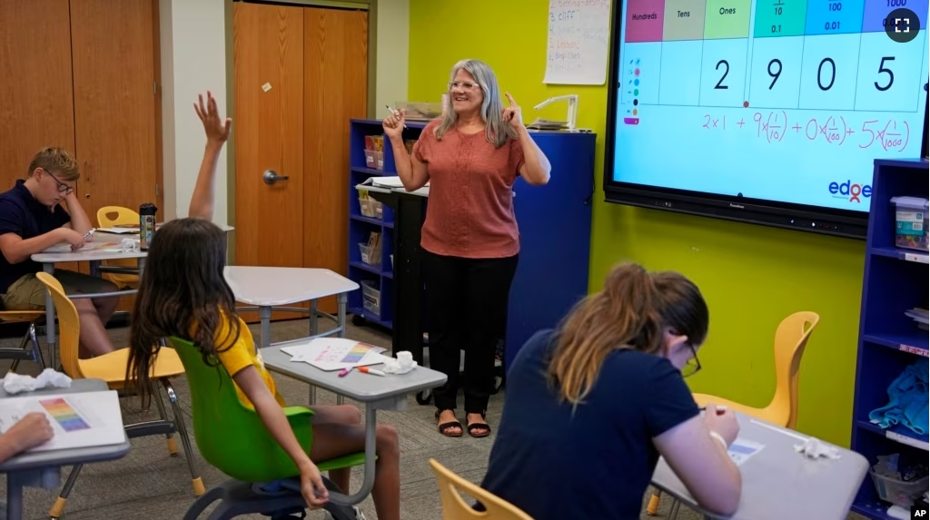 Elementary math teacher Margie Howells teaches a fifth-grade class at Wheeling Country Day School in Wheeling, WV, on Tuesday, Sept. 5, 2023. (AP Photo/Gene J. Puskar)