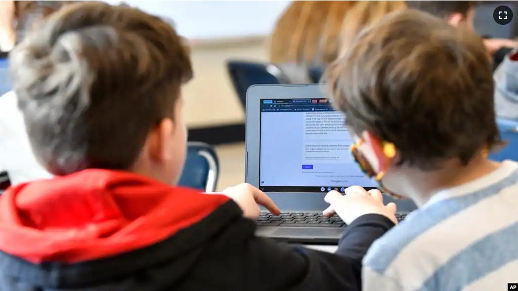 FILE - Michael Burton-Straub, left, and Declan Lewis attempt to "Find the Bot" in Donnie Piercey's class at Stonewall Elementary in Lexington, Ky., Monday, Feb. 6, 2023. (AP Photo/Timothy D. Easley)