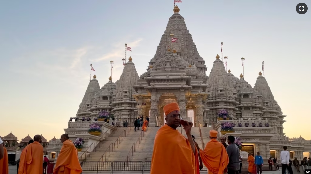 Monks walk in front of the BAPS Swaminarayan Akshardham, the largest Hindu temple outside India in the modern era, on Oct. 4, 2023, in Robbinsville, N.J. (AP Photo/Luis Andres Henao)