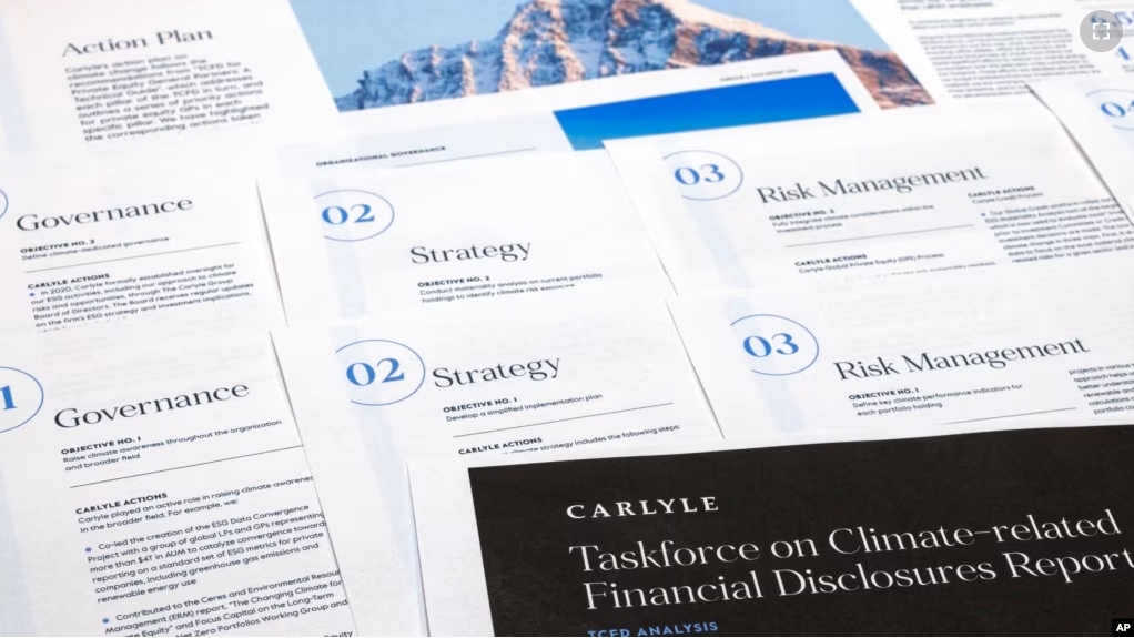 FILE - Pages from a Carlyle Group 2021 report on its financial risk from greenhouse gas emissions are photographed Tuesday, Sept. 20, 2022. Documents and contracts often contain what is called "boilerplate language." (AP Photo/Jon Elswick)