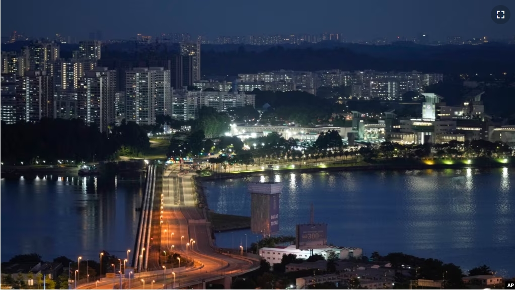 FILE - The Johor-Singapore Causeway lies empty in Johor Bahru, Malaysia, on Nov. 28, 2021. The urgency for Southeast Asian nations to switch to clean energy to combat climate change is reinvigorating a 20-year-old plan for the region to share power. (AP Photo/Vincent Thian, File)