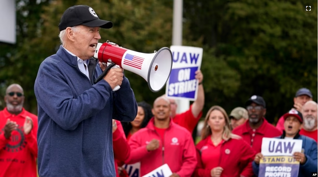 U.S. President Joe Biden joins striking United Auto Workers on the picket line, in Van Buren Township, Michigan on Sept. 26, 2023. (AP Photo/Evan Vucci)