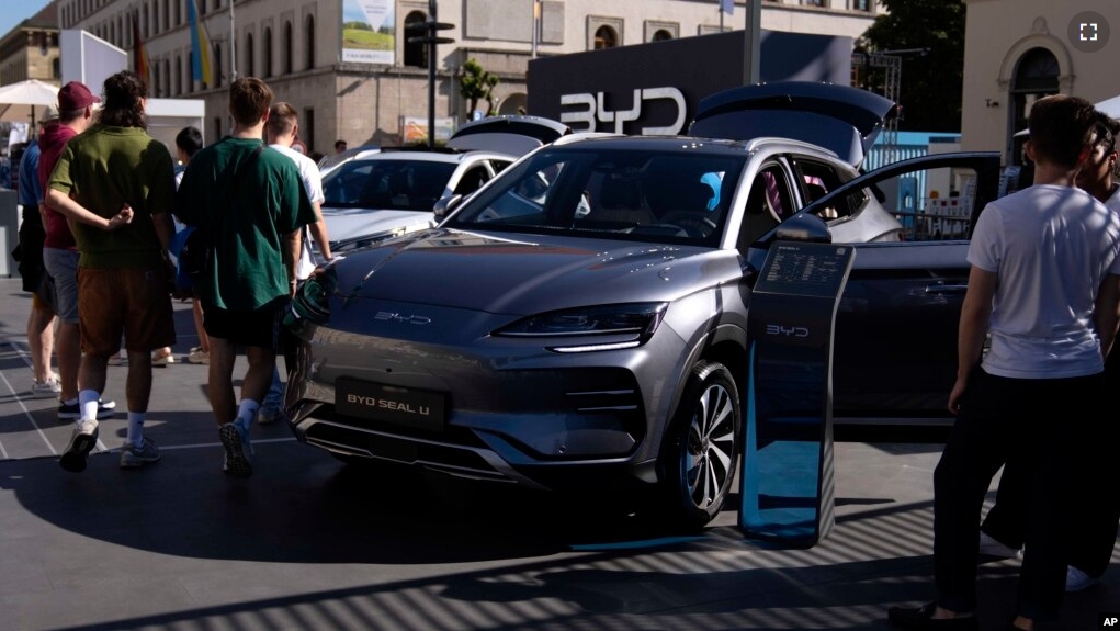 FILE - Visitors watch a BYD car at the IAA motor show in Munich, Germany, on Sept. 8, 2023. The European Union has launched an investigation into Beijing’s support for its EV industry, adding to tensions between the West and China. (AP Photo/Matthias Schrader, File)