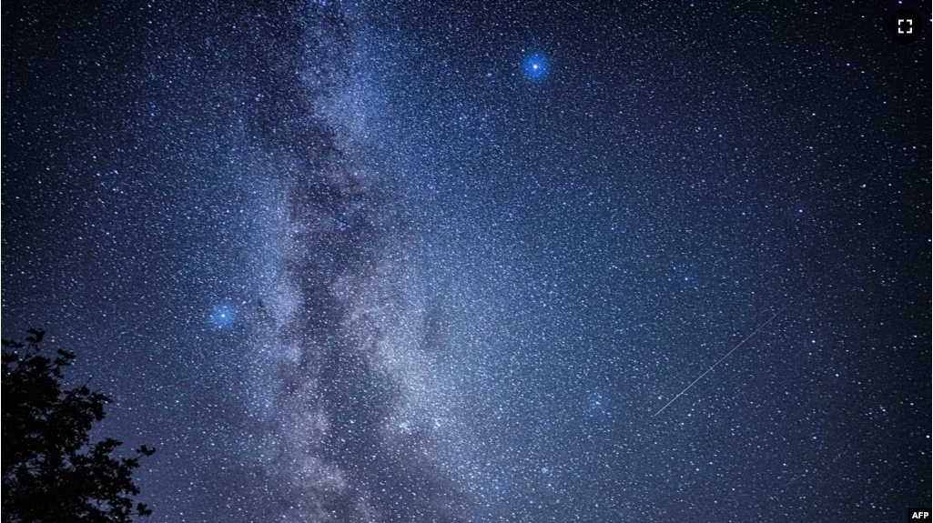 FILE - A picture taken in Fontainebleau, southern Paris on August 13, 2023 shows shooting stars streaking across the Milky Way during the "Nuits des étoiles" (Starry Night), a major annual celebration for astronomy enthusiasts. (Photo by Miguel MEDINA / AFP)