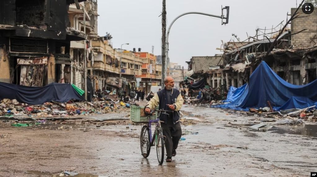 A Palestinian walks in Gaza City on Monday, Nov. 27, 2023. on the fourth day of the temporary ceasefire between Hamas and Israel. (AP Photo/Mohammed Hajjar)