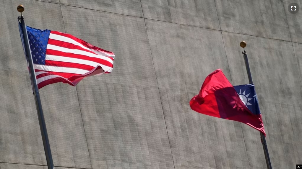 FILE - A U.S. and a Taiwanese flag flutter outside a hotel as Taiwan's president was staying in Los Angeles, California, April 4, 2023. (AP Photo/Damian Dovarganes, File)