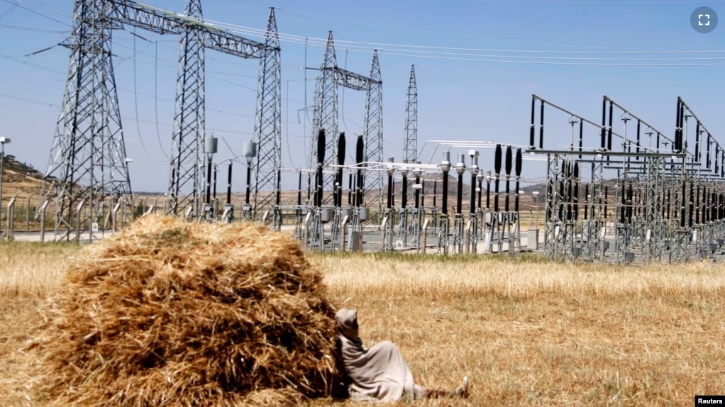 FILE - A farmer naps in a barley field next to an electricity power plant near a village in Mekelle, Tigray, Oct. 25, 2013. (REUTERS/Kumerra Gemechu)