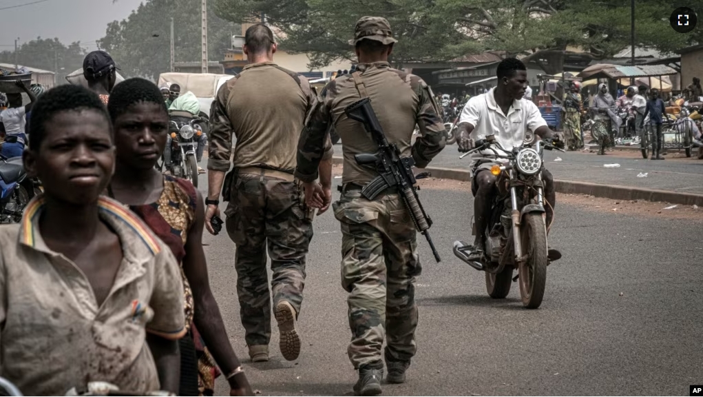 FILE - French army military instructors walk on one of the main roads in Tanguietan, northern Benin, March 28, 2022. (AP Photo/ Marco Simoncelli, File)