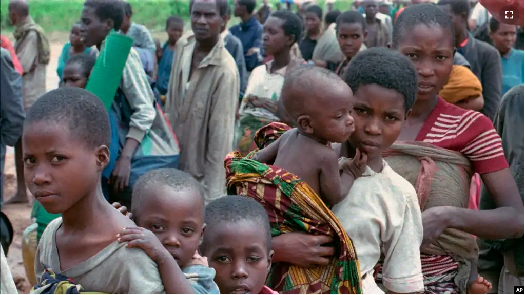 FILE — Hutu refugees women and children wait to be registered at Kigali airport Rwanda, after they arrived on the UN plane from Kisangai, Zaire Sunday, May 4, 1997. (AP Photo/Sayyid Azim, File)