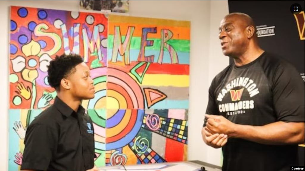 Jordan Williams, a student in the Deanwood Radio Broadcast Youth Journalism Program, interviews basketball legend Magic Johnson in Washington, D.C. (Courtesy Photo)