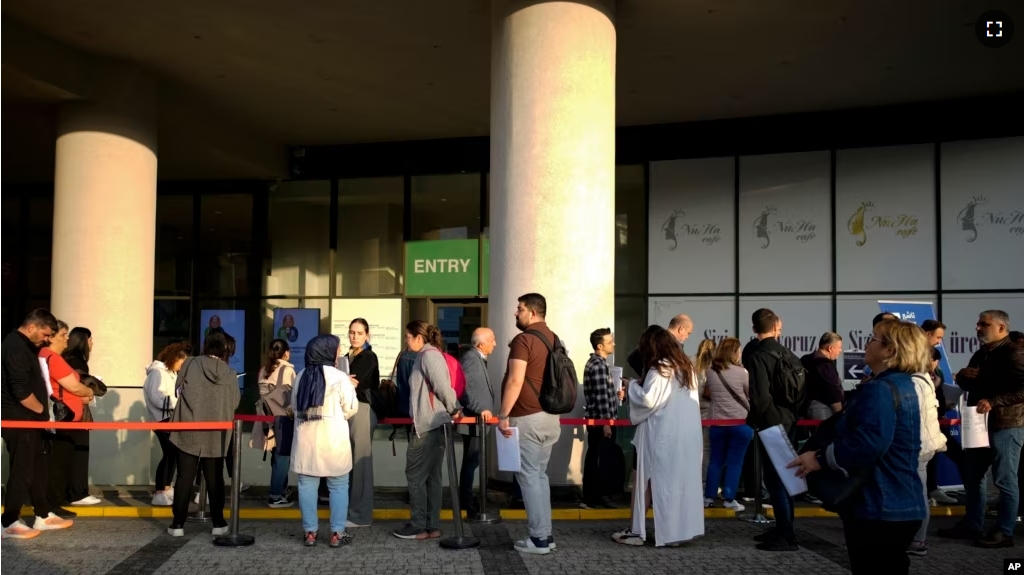 People wait for their turn at a visa application center, in Istanbul on November 3, 2023. (AP Photo/Emrah Gurel)