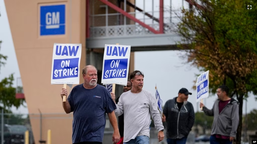 FILE - UAW members strike outside General Motors' assembly plant, Tuesday, Oct. 24, 2023, in Arlington, Texas. (AP Photo/Julio Cortez)