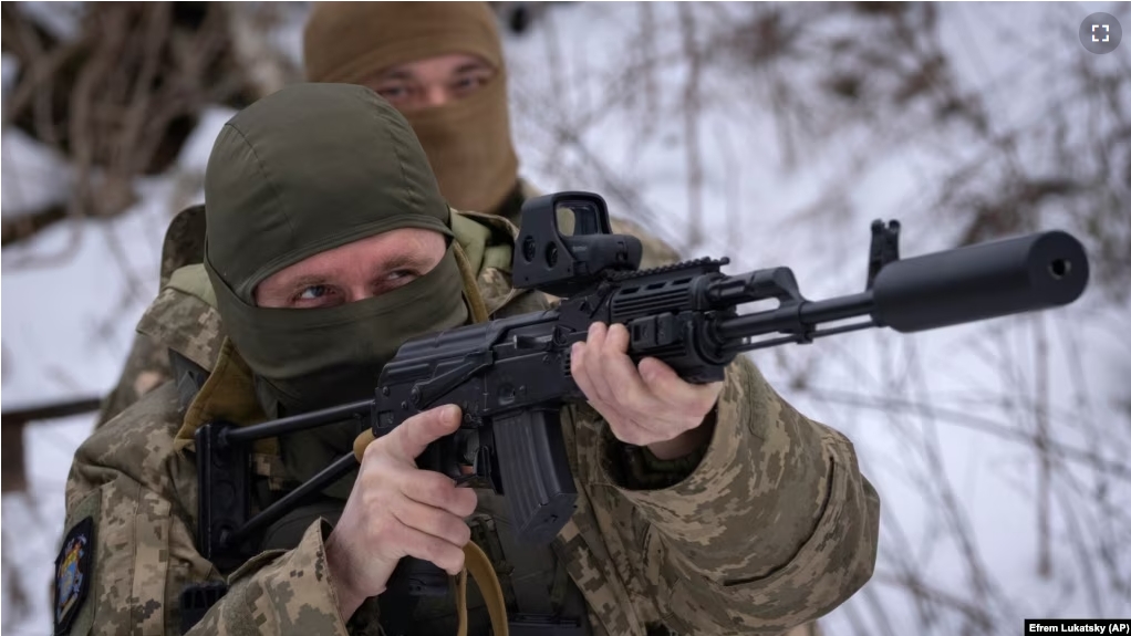 Members of the pro-Ukrainian Russian ethnic Siberian Battalion practice at a military training close to Kyiv, Ukraine, Wednesday, Dec. 13, 2023. (AP Photo/Efrem Lukatsky)