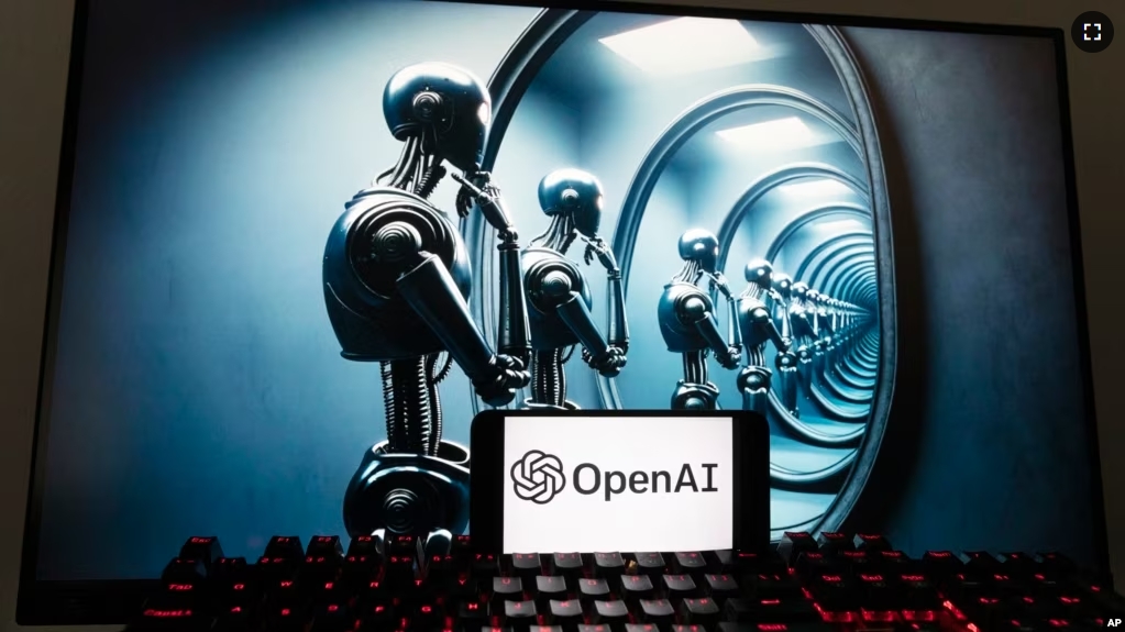 FILE - The OpenAI logo is seen displayed on a cell phone with an image on a computer screen generated by ChatGPT's Dall-E text-to-image model, Friday, Dec. 8, 2023, in Boston. (AP Photo/Michael Dwyer)