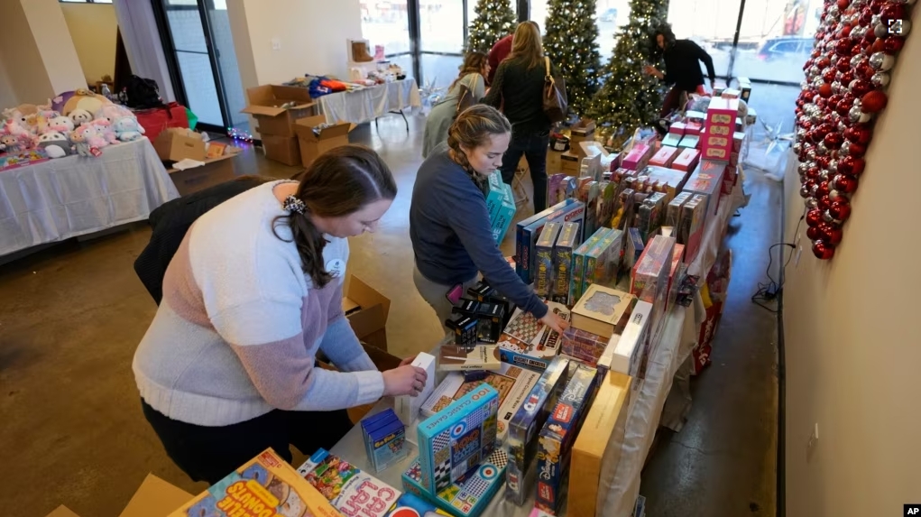 Workers arrange toys at The Toy Store, a free-referral based toy store on December 7, 2023, in Nashville, Tenn.(AP Photo/Mark Humphrey)