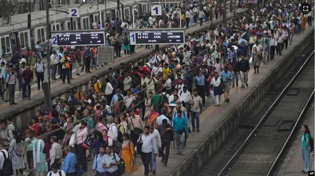 FILE - A busy platform is seen at Chhatrapati Shivaji Maharaj Terminus on World Population Day in Mumbai, India, Tuesday, July 11, 2023. (AP Photo/Rajanish Kakade)