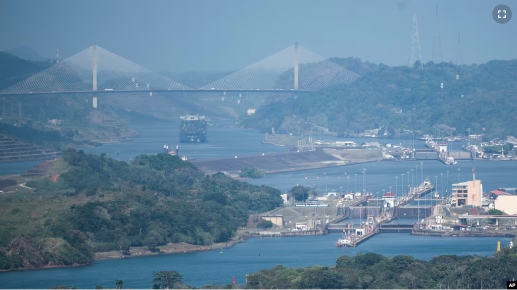 A cargo ship waits near the Centennial Bridge for transit through the Panama Canal locks, in Panama City, Wednesday, Jan. 17, 2024. (AP Photo/Agustin Herrera)