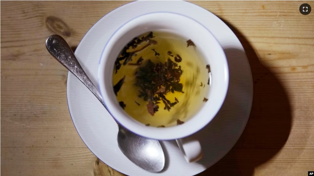 FILE - A cup of black tea with a spoon and tea leaves in London, on Aug. 29, 2022. An American scientist has started a tempest in a teapot by offering Britain advice on its favorite drink: tea. (AP Photo/Alastair Grant, File)