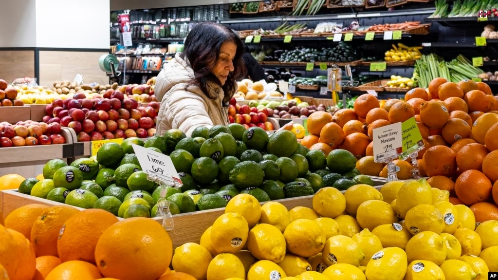 A woman browses produce for sale at a Whole Foods grocery store, Friday, Jan. 19, 2024, in New York. (AP Photo/Peter K. Afriyie)