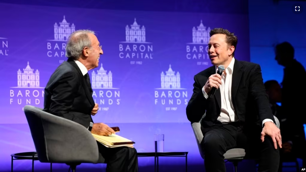 FILE - Baron Capital Group Chairman and CEO Ron Baron interviews Tesla CEO Elon Musk at the 29th Annual Baron Investment Conference in New York City on Friday, Nov. 4, 2022. (Hewes Communications, Inc. via AP)