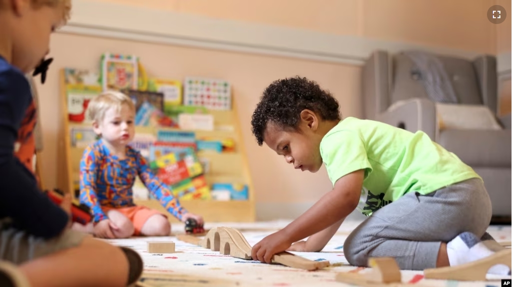 FILE - Elijah Rollings, 2, plays with a train set at Bumble Art Studio daycare center in Astoria, Ore., Friday, Sept. 2, 2022. (AP Photo/Craig Mitchelldyer)