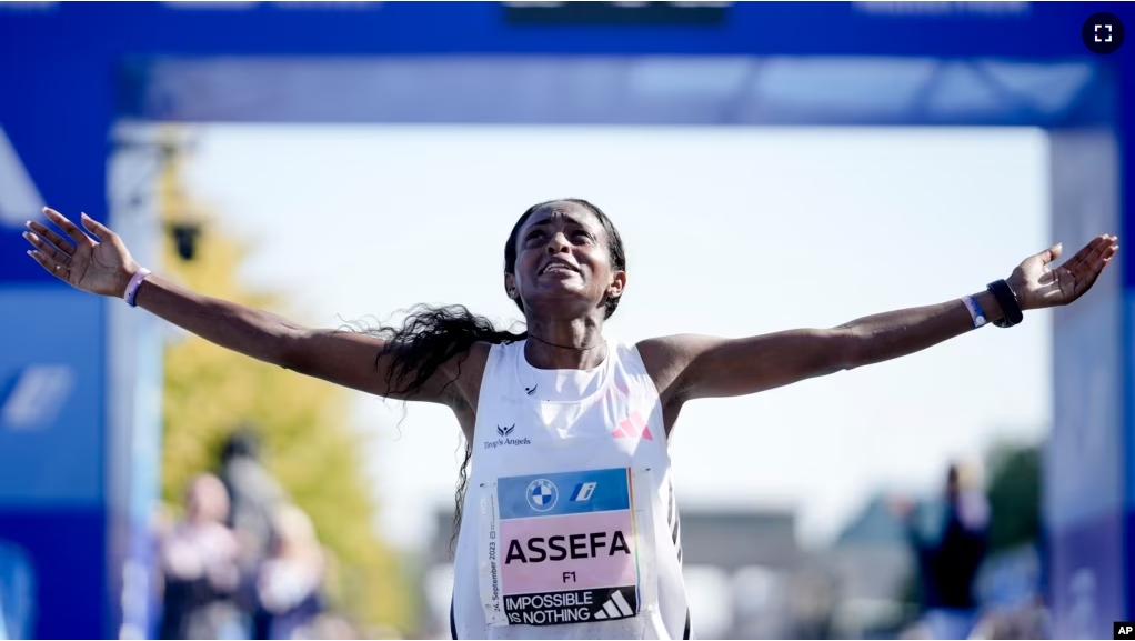 FILE - Ethiopia's Tigist Assefa celebrates as she crosses the finish line to win the women's division of the Berlin Marathon in world record time in Berlin, Germany, Sunday, Sept. 24, 2023. (AP Photo/Markus Schreiber)