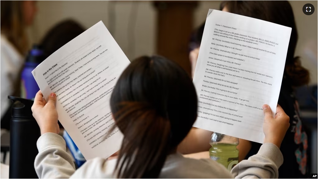 FILE - Jenes Ochoa Rojas goes over the lines of a three-scene play written by ChatGPT in Donnie Piercey's class at Stonewall Elementary in Lexington, Ky., Monday, Feb. 6, 2023. (AP Photo/Timothy D. Easley)