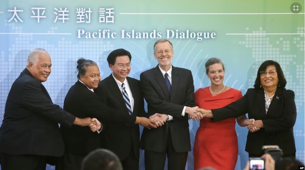 FILE - From left, Ambassador Jarden Kephas, Ambassador Limasene Teatu, Foreign Minister Joseph Wu, William Brent Christensen, Sandra Oudkirk, and Ambassador Neijon Rema Edwards at the Pacific Islands Dialogue in Taipei, Taiwan, on Oct. 7, 2019. (AP Photo/Chiang Ying-ying, File)