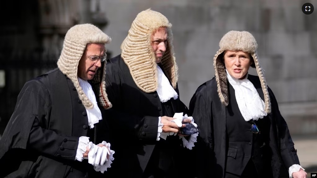 FILE - Judges cross the road toward Parliament after a Service at Westminster Abbey for the opening of the new legal year in London, Friday, Oct. 1, 2021. (AP Photo/Frank Augstein)