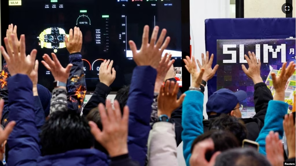 People raise their hands after a moon landing by the Smart Lander for Investigating Moon (SLIM), in a public viewing event in Sagamihara, south of Tokyo, Japan January 20, 2024. (REUTERS/Kim Kyung-Hoon)