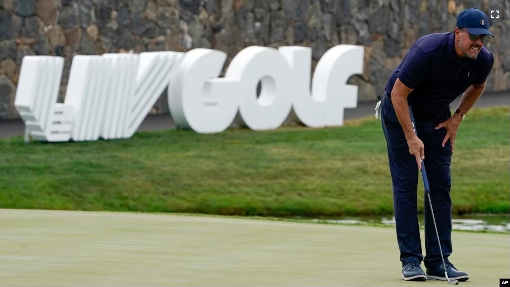 FILE - Phil Mickelson lines up a shot on the 18th hole during the first round of the Bedminster Invitational LIV Golf tournament in Bedminster, N.J., July 29, 2022. (AP Photo/Seth Wenig, File)