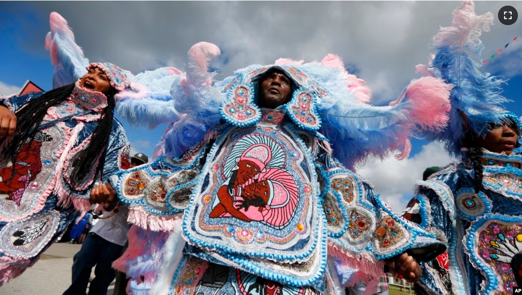 FILE - The Cheyenne and 7th Ward Creole Hunters Mardi Gras Indians are pictured at the New Orleans Jazz and Heritage Festival in New Orleans, May 4, 2017. (AP Photo/Gerald Herbert)